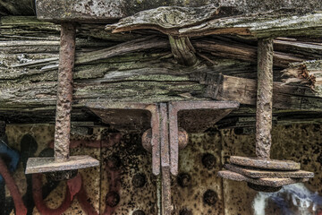 Rotting wood and bolts of an old girder bridge