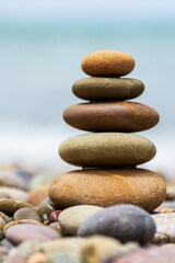 Pyramid stones balance on the beach. Calm. Zen-like concept.