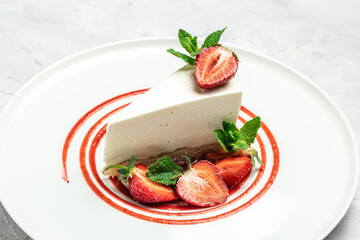 Strawberry Cheesecake with Strawberry Syrup. piece of cheesecake decorated with strawberry sauce on white background