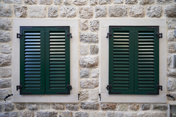 Fototapeta na wymiar Green plastic shutters on windows, home improvement concept