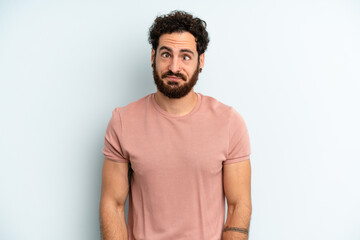 young adult bearded man looking goofy and funny with a silly cross-eyed expression, joking and fooling around
