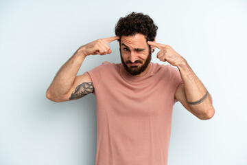young adult bearded man with a serious and concentrated look, brainstorming and thinking about a...