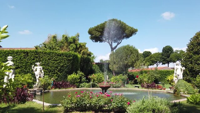 Fountain and scuplures in typical Italian garden in the Tuscany - Steady shot