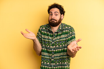 young adult bearded man feeling puzzled and confused, unsure about the correct answer or decision,...