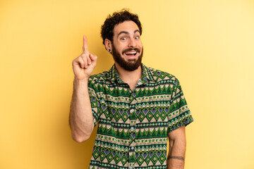 young adult bearded man feeling like a happy and excited genius after realizing an idea, cheerfully...