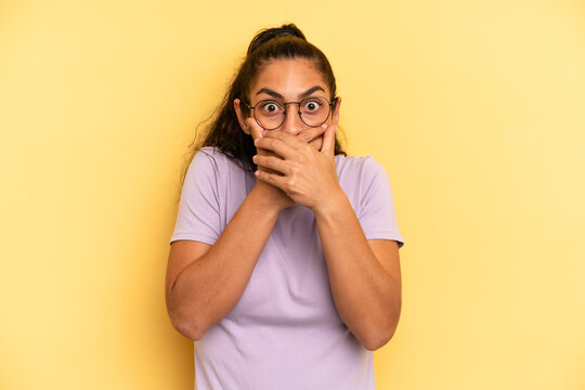 hispanic pretty woman covering mouth with hands with a shocked, surprised expression, keeping a secret or saying oops