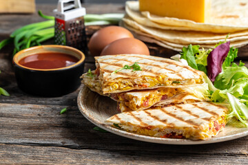 Mexican tortilla quesadilla with scramble eggs, vegetables, ham and cheese, Mexican cuisine, Mexico and Latin America traditional restaurant menu dish, food cooking recipe book cover