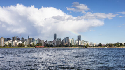 Fototapeta premium Downtown Vancouver City Skyline with clouds and rainbow. False Creek, British Columbia, Canada. Modern Cityscape on West Coast of Pacific Ocean.