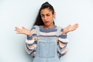 hispanic pretty woman shrugging with a dumb, crazy, confused, puzzled expression, feeling annoyed...