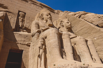 The main view of an Entrance to the Great Temple at Abu Simbel with Ancient Colossal statues of...
