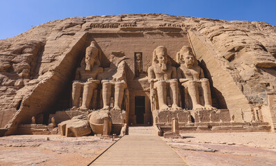 The main view of an Entrance to the Great Temple at Abu Simbel with Ancient Colossal statues of...