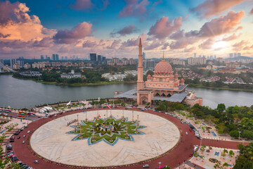 Aerial View Of Putra Mosque with Putrajaya City Centre with Lake at sunset in Putrajaya, Malaysia.