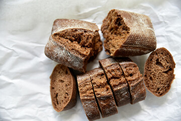 Rolls of rye black bread on white paper