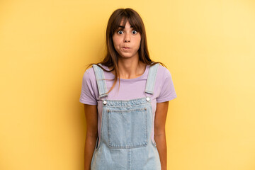 hispanic pretty woman with a goofy, crazy, surprised expression, puffing cheeks, feeling stuffed,...