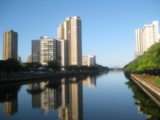 Ala Wai Canal in Honolulu, Hawaii reflecting the modern tall buildings around it