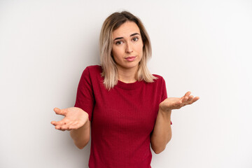 young adult blonde woman feeling puzzled and confused, unsure about the correct answer or decision,...
