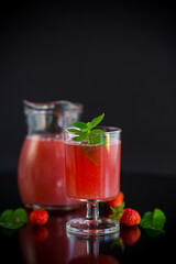 Cold summer strawberry kvass with mint in a glass