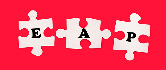 Three white jigsaw puzzles with the text EAP Employee Assistance Program on a bright red background.