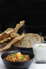 Baigan or Baingan Bharta-Roasted and mashed eggplant is traditional Indian food,served with papad,bajra roti or bhakhri.