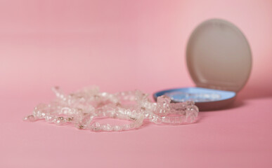 invisible brace in case on pink background