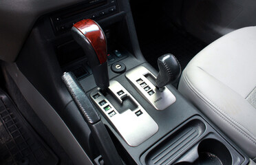 Close up of the automatic gearbox lever SUV, black interior car. Off road Automatic transmission...