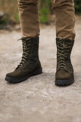 Military man in dark green leather tactical boots