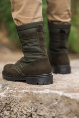 Military man in dark green leather tactical boots