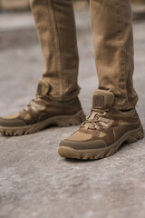 Military man in beige leather tactical sneakers
