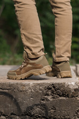 Military man in beige leather tactical sneakers