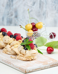 A baked cake made from whipped chicken protein and cream, decorated with fresh berries.