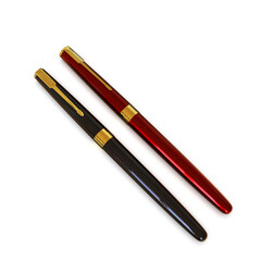 Collection of black and dark red ballpoint pens.