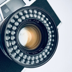 Vintage analog camera lens on isolated light background | close-up object