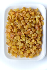 Juicy yellow raisins on a white backing