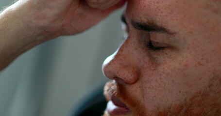 Fototapeta premium Pensive man looking for solution to problem, redhair guy seeking help of God looking up