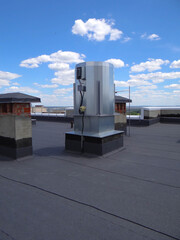 Obraz premium smoke extraction fan on the roof.brick shaft of natural ventilation.waterproofing of the roof of the building.