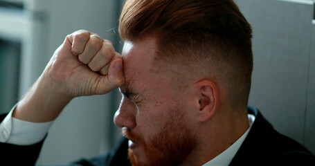 Fototapeta premium Pensive business man sitting on floor in frustration