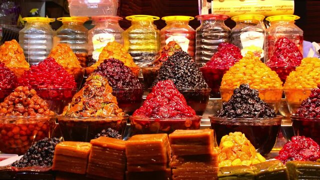 Piles of various colorful tasty candy sweets on bazaar for sale in iranian street market