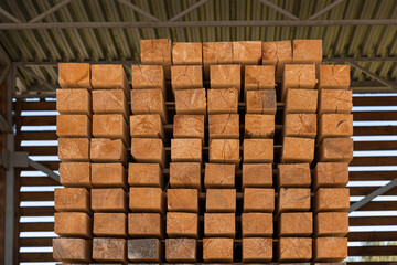 Smooth wooden flat boards in a warehouse, front view, close up