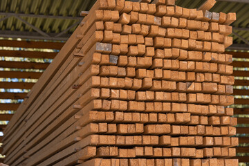 Smooth wooden flat boards in a warehouse, front view, close up