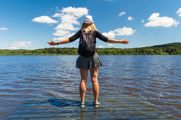Young woman with hat standing on wooden platform in pond from back, educational trail Olsina. Sumava reserve, Czech summer landscape - 515462841