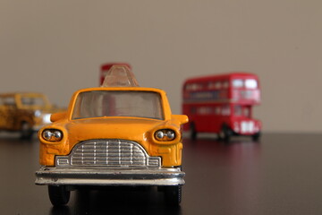 Miniature of New Yourk yellow taxi cab with Londo double bus at background