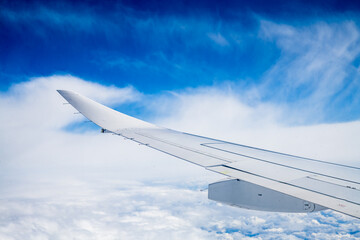 the wing of the aircraft against the background of the blue sky