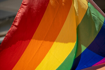 Multi-colored flags for gay pride and LGBT+ during gay pride week in the city of Madrid