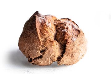 Round bread close-up on white background. Freshly baked sourdough bread with a golden crust. Baker shop context with delicious bread.