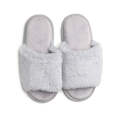 Pair of soft fluffy slippers on white background, top view