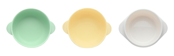 Set with colorful plastic bowls on white background, top view. Serving baby food