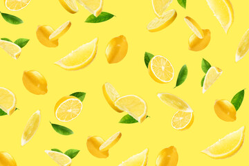 Fresh ripe lemons and green leaves flying on yellow background