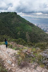 Fototapeta premium Young woman walking on Bogota mountain path 