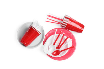 Set of bright disposable tableware on white background, top view