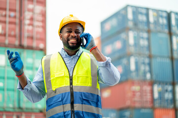 African American use mobile phone to talk with other and express happiness in cargo container workplace area.